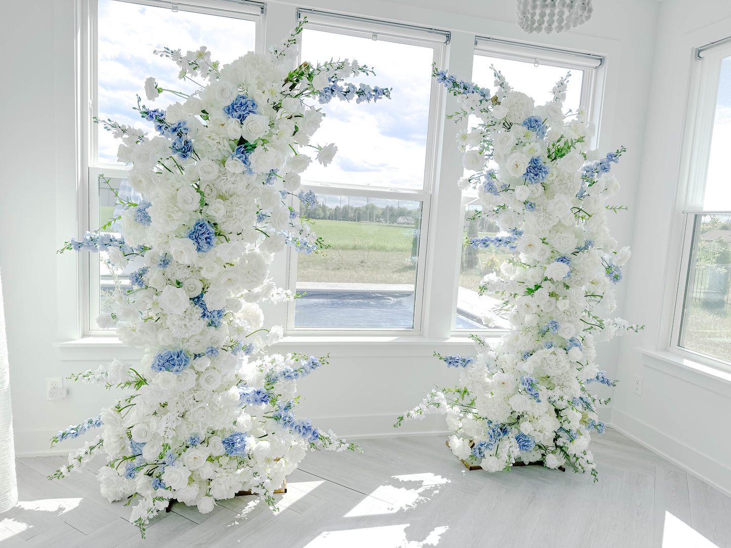 White and dusty blue wedding arch