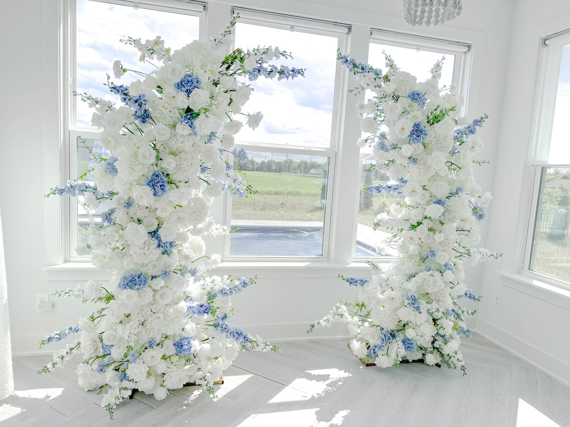 White and dusty blue wedding arch
